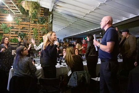 Audience engaging with a performer at a French-themed event in Sydney