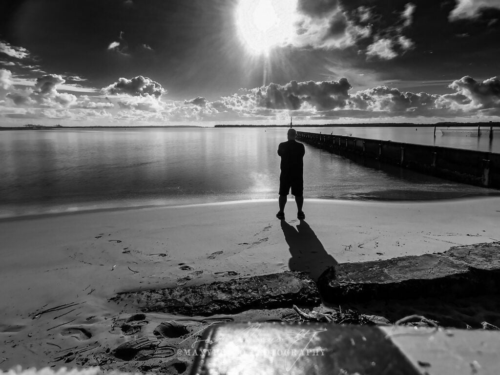 "Gazing out at the endless horizon, with the sun just starting to peek over the horizon, and the long shadow of the morning casting its eerie spell across the sand, the breakwater juts out into the bay providing a leading line that guides the eye to the endless possibilities of a new day. Captured at the break of dawn, this photo taken by a Sans Souci photographer captures the peaceful yet powerful moment that can only be found in the great outdoors."